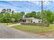 Charming single-story home featuring a fenced yard, mature trees, and well-maintained landscaping at 8301 Washington Blvd, Charlotte, NC 28262