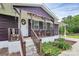 Charming home with a cozy covered front porch, perfect for relaxing and enjoying the outdoors at 8301 Washington Blvd, Charlotte, NC 28262