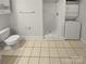 Bathroom featuring a shower, toilet, and stacked washer dryer at 8929 Meadow Vista Rd, Charlotte, NC 28213