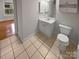 Bright bathroom features a vanity with storage, tile floors, and neutral paint at 8929 Meadow Vista Rd, Charlotte, NC 28213