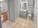 Full bathroom showcasing white vanity, neutral tile floor, modern fixtures, and natural light at 8929 Meadow Vista Rd, Charlotte, NC 28213