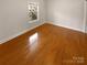 A bright bedroom with hardwood floors and a window at 8929 Meadow Vista Rd, Charlotte, NC 28213