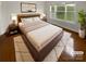 Cozy bedroom showcasing a plush bed, stylish decor, and a bright window overlooking a serene outdoor view at 8929 Meadow Vista Rd, Charlotte, NC 28213