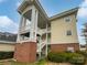 Inviting exterior view showcasing the building's architecture with covered stairways and manicured landscaping at 8929 Meadow Vista Rd, Charlotte, NC 28213