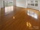 Spacious living room features hardwood floors and large windows, providing ample natural light and an airy feel at 8929 Meadow Vista Rd, Charlotte, NC 28213