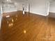 Hardwood floors in an open concept living space flow into the adjacent kitchen and dining area at 8929 Meadow Vista Rd, Charlotte, NC 28213
