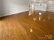 Expansive living area featuring gleaming hardwood floors and an open layout perfect for entertaining at 8929 Meadow Vista Rd, Charlotte, NC 28213