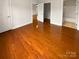 Main bedroom showcasing hardwood floors and ensuite bath with walk-in shower at 8929 Meadow Vista Rd, Charlotte, NC 28213