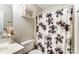 Cozy bathroom featuring a toilet and floral shower curtain at 9052 Meadowmont View Dr, Charlotte, NC 28269
