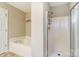 Clean bathroom featuring a tub, a separate shower with modern fixtures, and shelving for storage to add convenience at 9052 Meadowmont View Dr, Charlotte, NC 28269