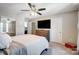 Cozy bedroom featuring a large bed, mounted TV, dresser and a bright atmosphere at 9052 Meadowmont View Dr, Charlotte, NC 28269