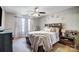 Bright bedroom with a ceiling fan, neutral walls, and a comfortable bed with stylish decor at 9052 Meadowmont View Dr, Charlotte, NC 28269