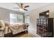 Carpeted bedroom featuring a ceiling fan, large windows and a mirrored closet for ample storage at 9052 Meadowmont View Dr, Charlotte, NC 28269