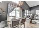 Cozy dining area connected to the living room, featuring a table set for four at 9052 Meadowmont View Dr, Charlotte, NC 28269