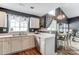 Open kitchen featuring stainless appliances, white cabinets, gray walls, and a seamless transition to the dining area at 9052 Meadowmont View Dr, Charlotte, NC 28269