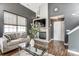 Cozy living room with modern fireplace, TV, and a white sofa near a bright window at 9052 Meadowmont View Dr, Charlotte, NC 28269