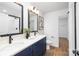 Modern bathroom features a dual sink vanity, black fixtures, and a glass-enclosed shower at 1034 Dooley Dr, Charlotte, NC 28227