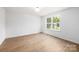 Bedroom with modern flooring, neutral walls, and a window with natural light at 1034 Dooley Dr, Charlotte, NC 28227