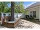 Spacious backyard featuring a built-in tree surround on the deck, dining area, and a privacy fence at 11841 Mourning Dove Ln, Charlotte, NC 28269