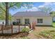 Charming backyard has a wooden deck, green lawn, and is partially fenced for privacy at 11841 Mourning Dove Ln, Charlotte, NC 28269