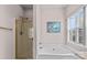 The bathroom offers a tub, glass shower, and natural light from the window at 11841 Mourning Dove Ln, Charlotte, NC 28269
