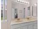 Well-lit bathroom features a dual sink vanity, a large mirror, and neutral decor at 11841 Mourning Dove Ln, Charlotte, NC 28269