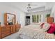 Bright bedroom with tray ceiling, large window, and wooden furniture at 11841 Mourning Dove Ln, Charlotte, NC 28269