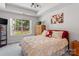 Bright bedroom with tray ceiling and a scenic view from the large window at 11841 Mourning Dove Ln, Charlotte, NC 28269