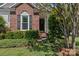 Charming brick entrance with lush green landscaping leading to the front door at 11841 Mourning Dove Ln, Charlotte, NC 28269