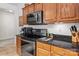 Updated kitchen features wooden cabinets, black granite countertops, and stainless steel appliances at 11841 Mourning Dove Ln, Charlotte, NC 28269