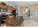Bright kitchen boasts tile flooring, wooden cabinets, stainless steel appliances, and an island at 11841 Mourning Dove Ln, Charlotte, NC 28269
