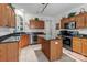 Well-equipped kitchen with stainless steel appliances, granite countertops and center island at 11841 Mourning Dove Ln, Charlotte, NC 28269