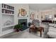 Comfortable living room with a fireplace, built-in shelving, and neutral carpet at 11841 Mourning Dove Ln, Charlotte, NC 28269