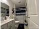 Neutral bathroom features a white sink and cabinet with silver and blue accents at 123 Grey Fox Ln, Mount Gilead, NC 27306