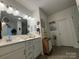 Bright bathroom features a double sink vanity, decorative accents, and neutral tiling at 123 Grey Fox Ln, Mount Gilead, NC 27306
