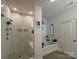 Modern bathroom with glass enclosed shower, soaking tub, and neutral color palette at 123 Grey Fox Ln, Mount Gilead, NC 27306