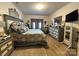 Comfortable bedroom featuring a decorative bedspread, wood floors, and a stylish dresser at 123 Grey Fox Ln, Mount Gilead, NC 27306