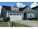 Charming home with a two-car garage, gray siding and white trim, showcasing curb appeal at 123 Grey Fox Ln, Mount Gilead, NC 27306