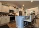 Modern kitchen featuring stainless steel appliances, a breakfast bar, and seamlessly connected dining area at 123 Grey Fox Ln, Mount Gilead, NC 27306
