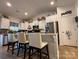 Well-lit kitchen with an expansive island, sleek countertops, a modern stainless steel refrigerator and pantry at 123 Grey Fox Ln, Mount Gilead, NC 27306