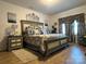Luxurious main bedroom with a large decorative headboard, matching nightstands, and stylish window treatments at 123 Grey Fox Ln, Mount Gilead, NC 27306
