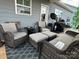Cozy covered patio features wicker furniture, plush cushions, and outdoor grill for entertaining at 123 Grey Fox Ln, Mount Gilead, NC 27306