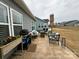 Outdoor living on a concrete patio with grill, seating, and umbrella overlooking the backyard at 123 Grey Fox Ln, Mount Gilead, NC 27306