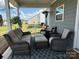 Comfortable covered patio with stylish wicker furniture, perfect for outdoor living at 123 Grey Fox Ln, Mount Gilead, NC 27306