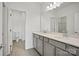 Well-lit bathroom with double sink vanity, large mirror, and tile flooring at 13737 Roderick Dr # 186, Huntersville, NC 28078