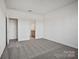 Spacious bedroom featuring carpet, white walls, and doorway leading to the bathroom at 13737 Roderick Dr # 186, Huntersville, NC 28078