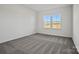 Bright bedroom with neutral carpet and double windows offering natural light at 13737 Roderick Dr # 186, Huntersville, NC 28078