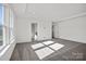 Spacious bedroom with tray ceiling, large windows, and neutral carpet for a bright, modern feel at 13737 Roderick Dr # 186, Huntersville, NC 28078
