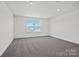 A bedroom featuring plush gray carpet and double windows at 13737 Roderick Dr # 186, Huntersville, NC 28078