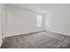 Well-lit bedroom with neutral carpeting, a large window, and fresh paint for a modern, comfortable feel at 13737 Roderick Dr # 186, Huntersville, NC 28078